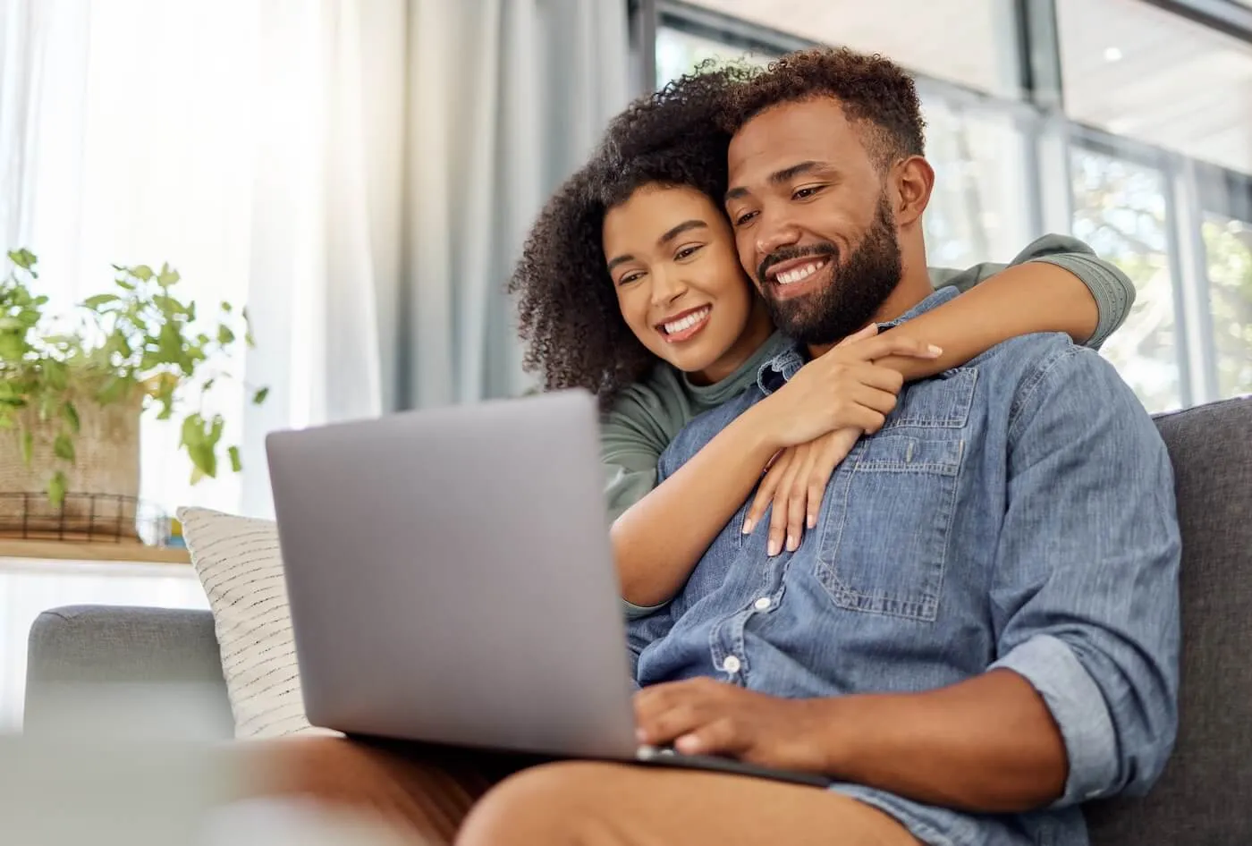 Happy young couple opening CD account on their laptop