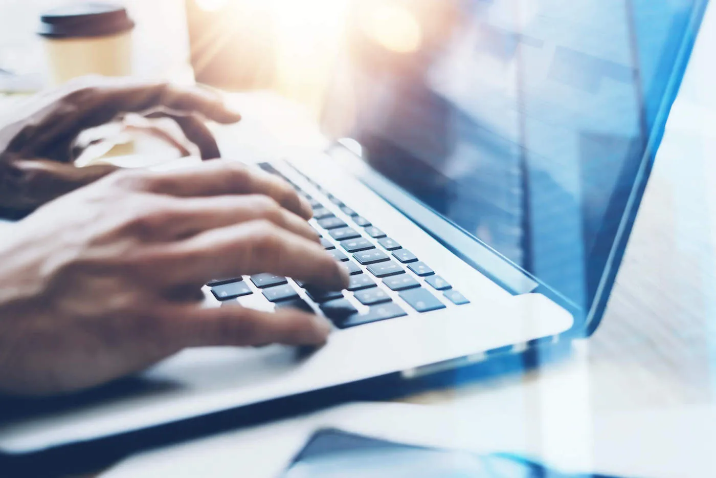 Male hands typing on notebook keyboard.