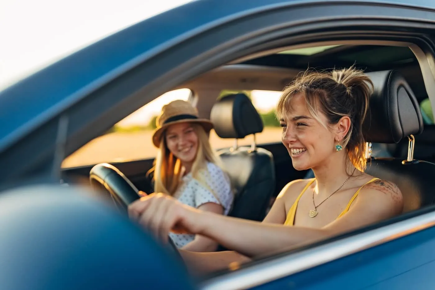 Two happy young women enjoying a roadtrip