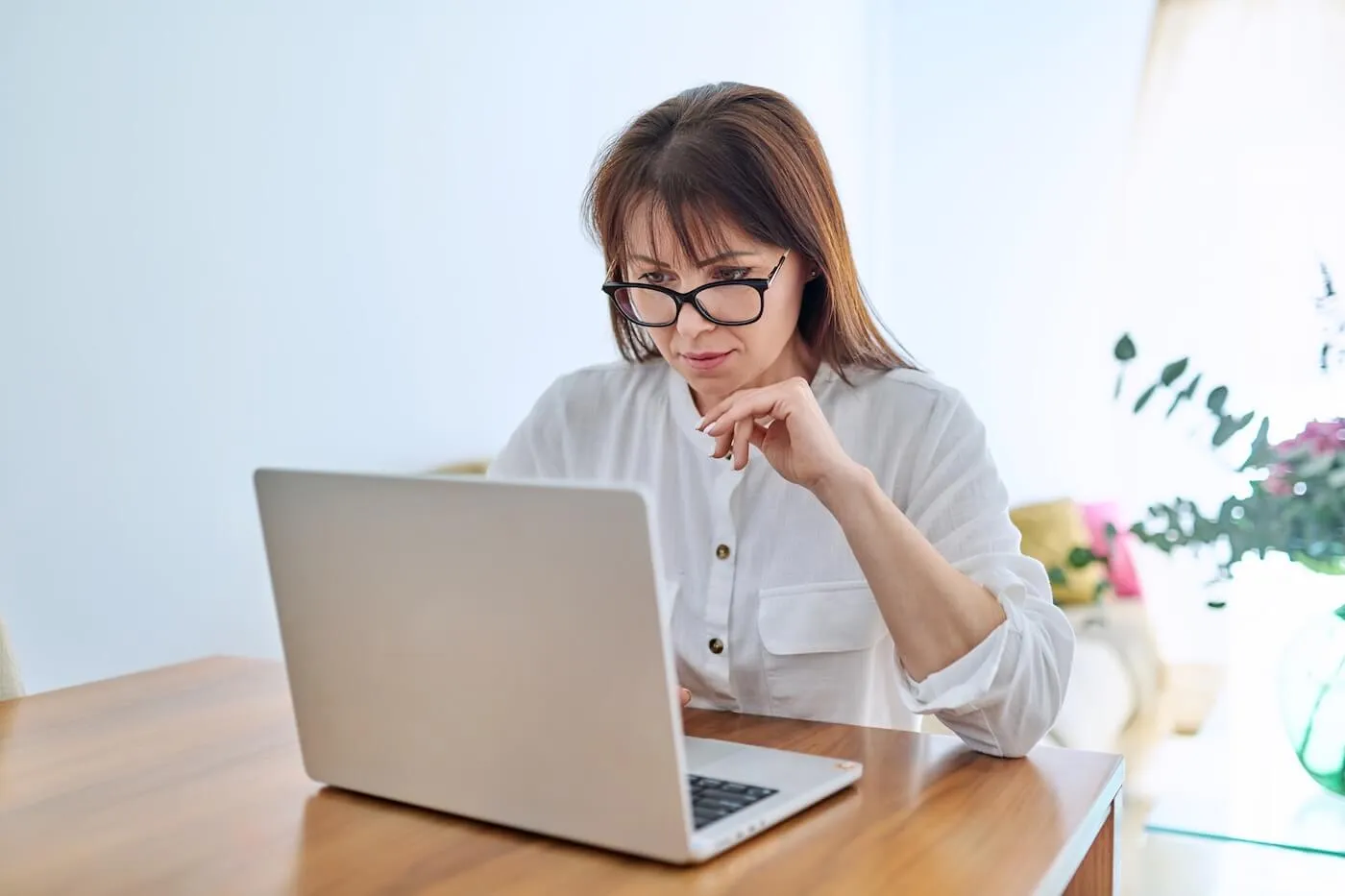 Focused woman working on her laptop at home