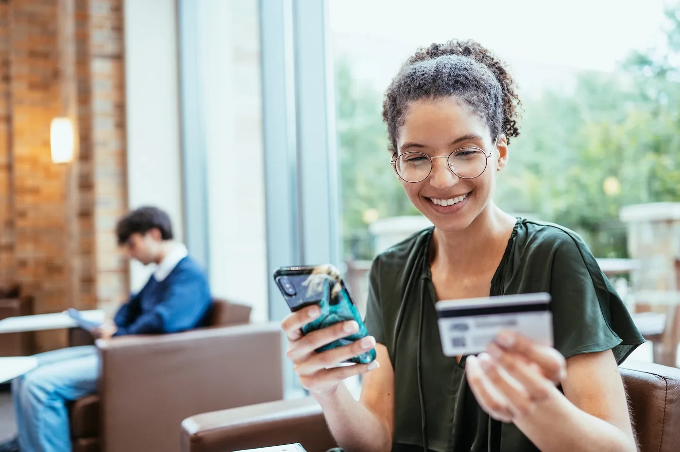 Young woman using credit card for online payment.