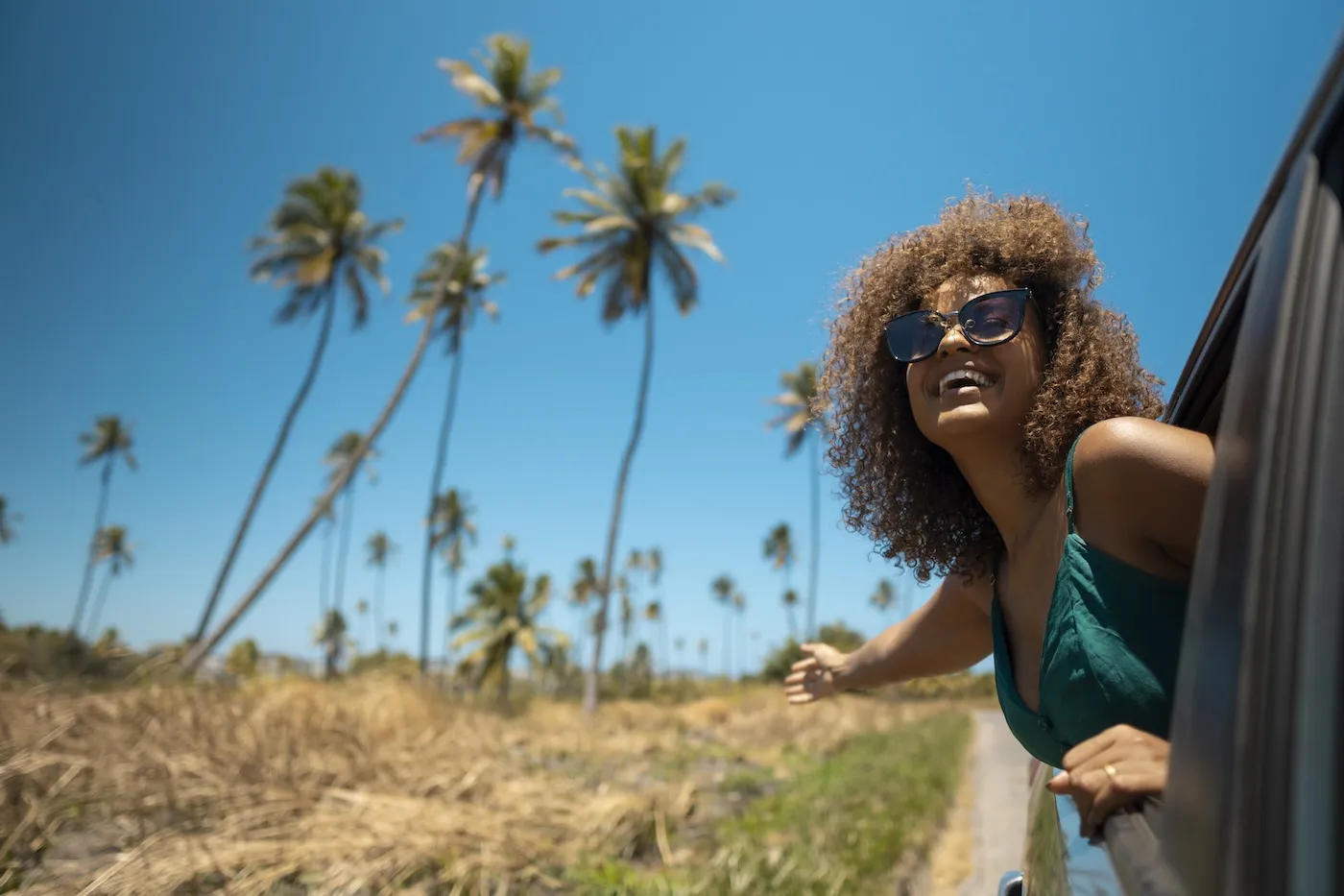 A woman on a tropical beach road trip.