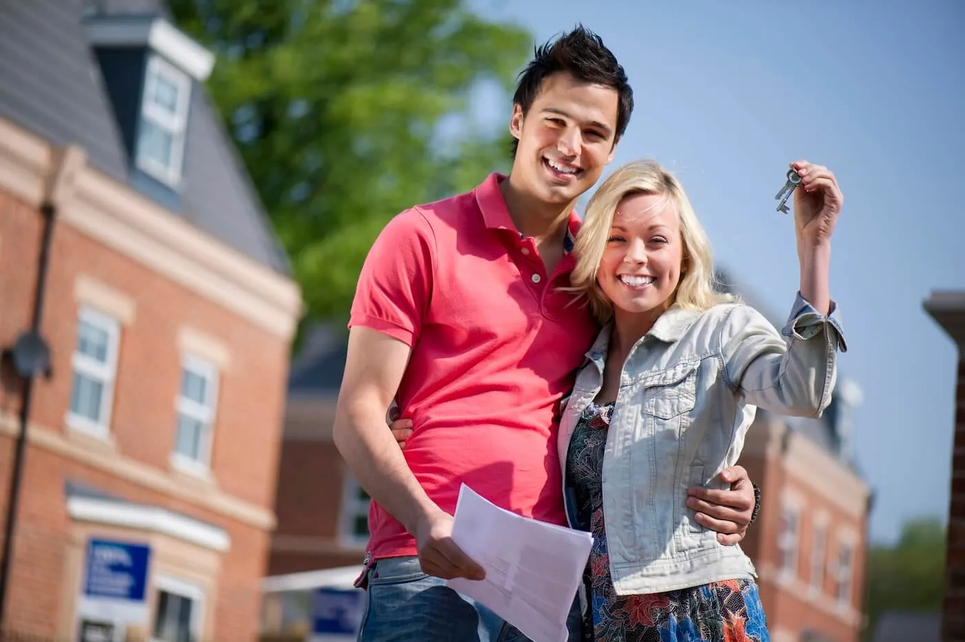 Happy young couple holding the keys to their new house