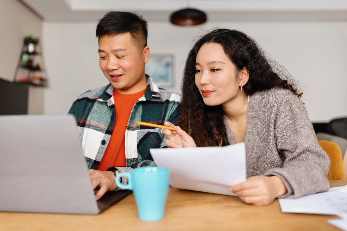 Young couple filing taxes online at home