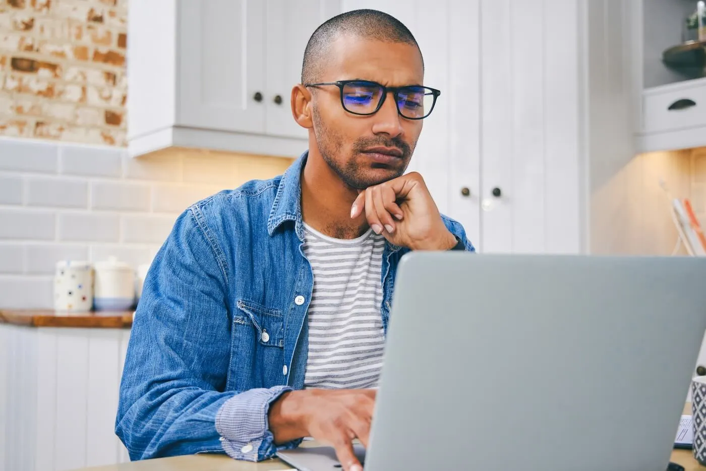 Young man working on his laptop at home