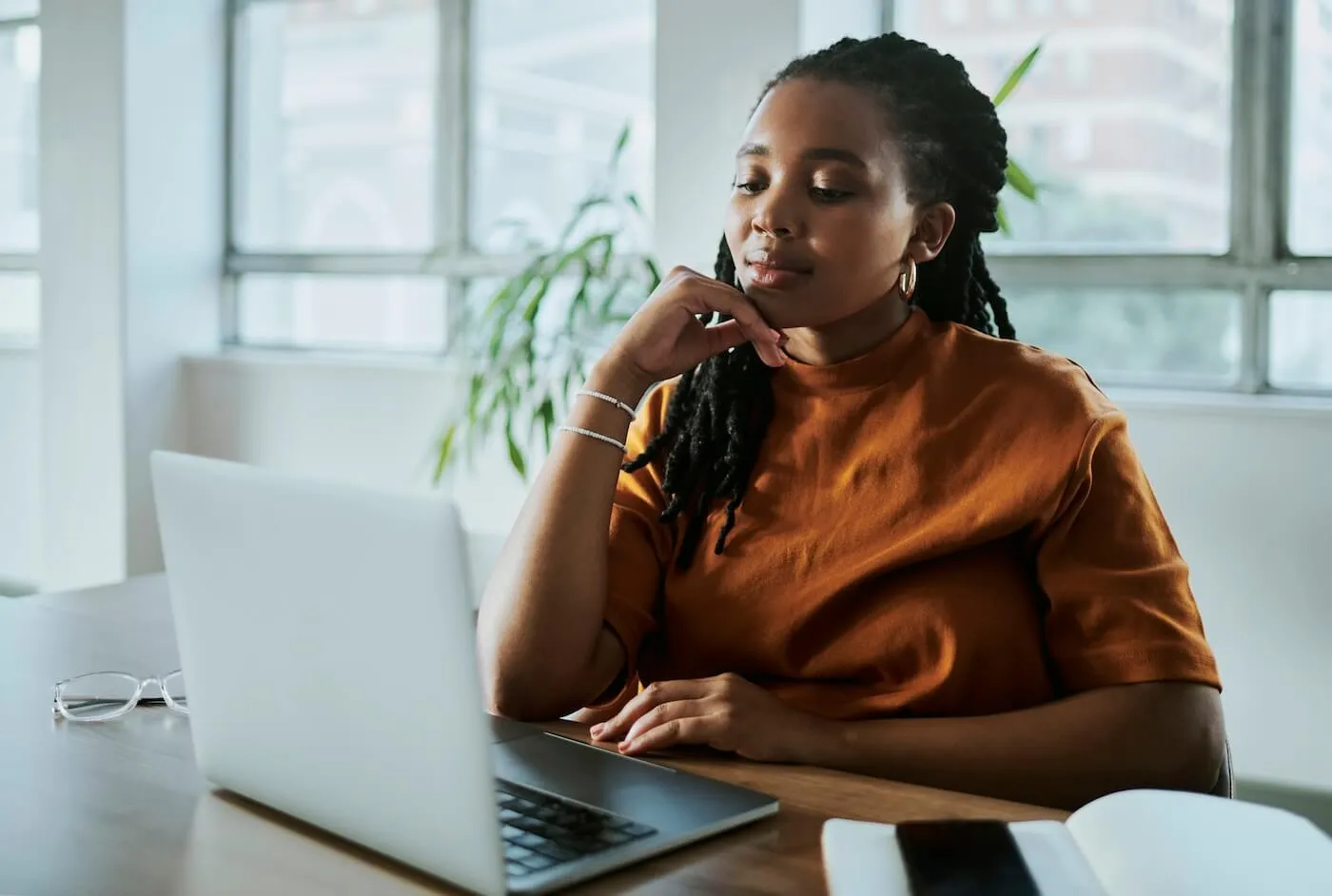 Young woman using laptop in a home office