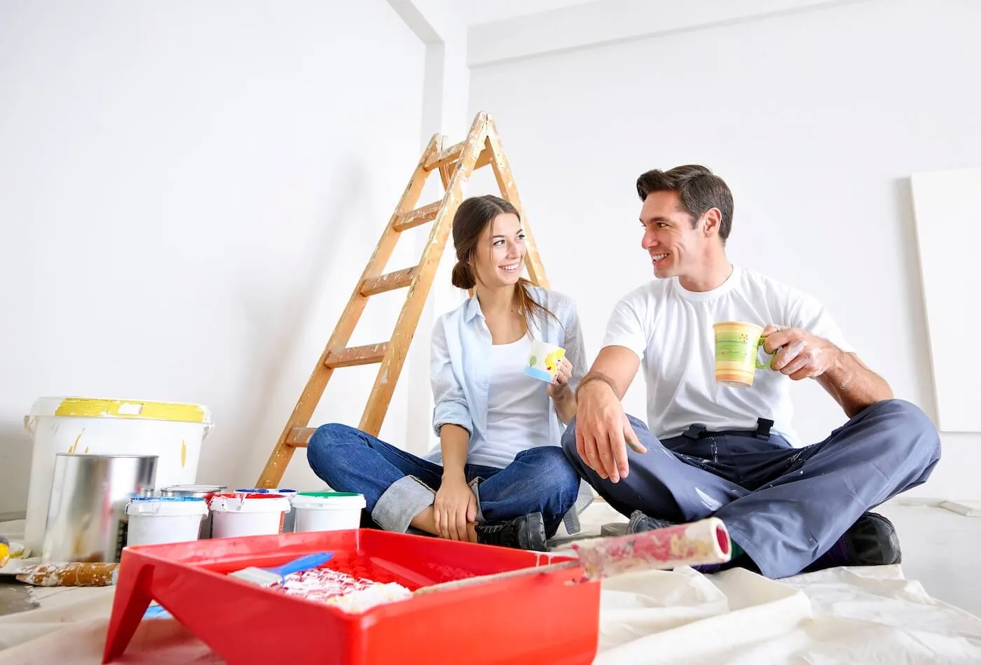 Young couple taking a coffee break during a home renovation
