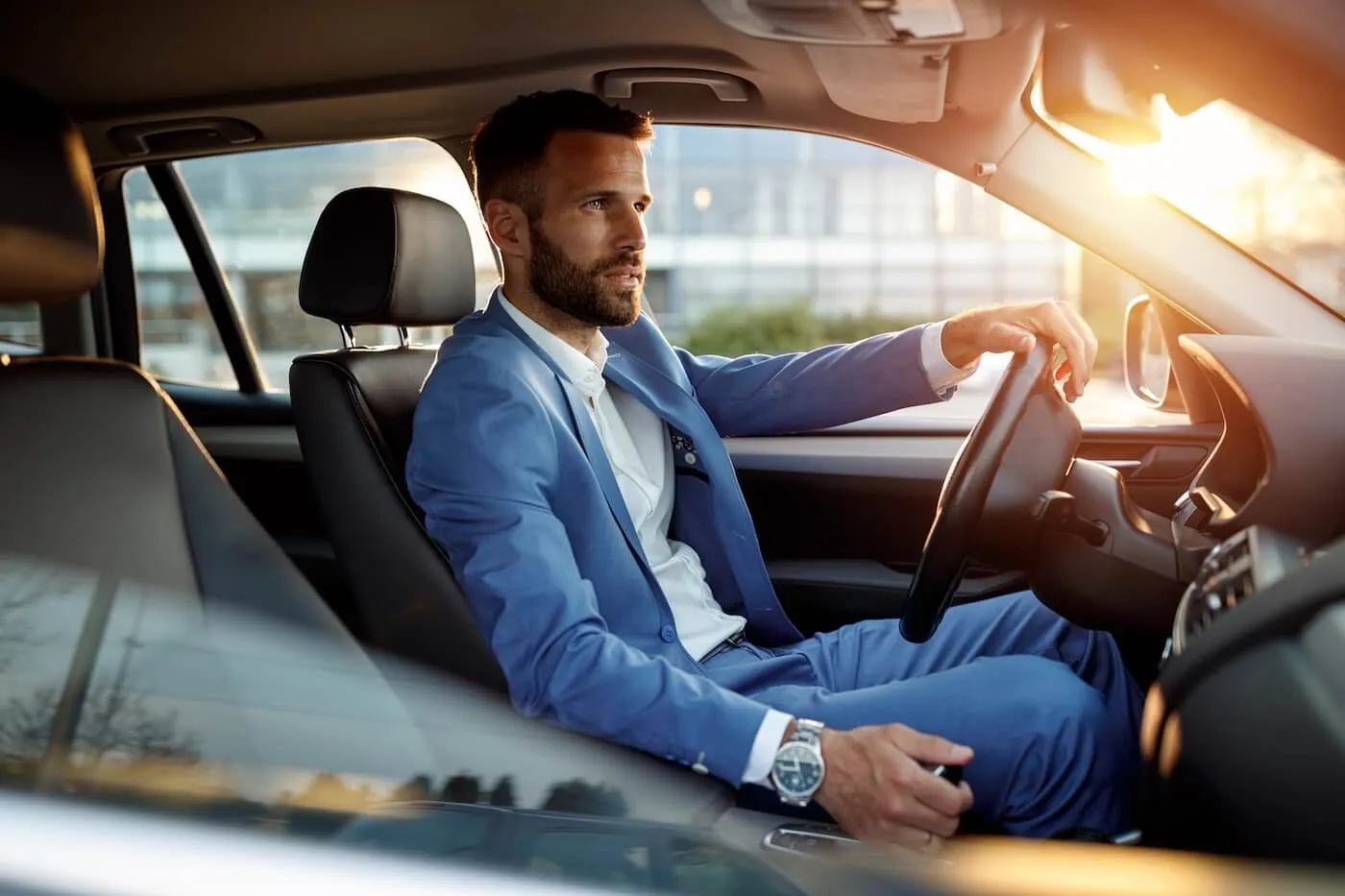Focused businessman sitting in the car behind the wheel
