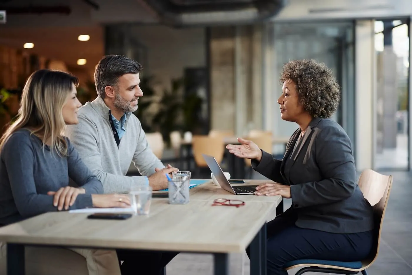 Couple discussing personal loan options with the female agent