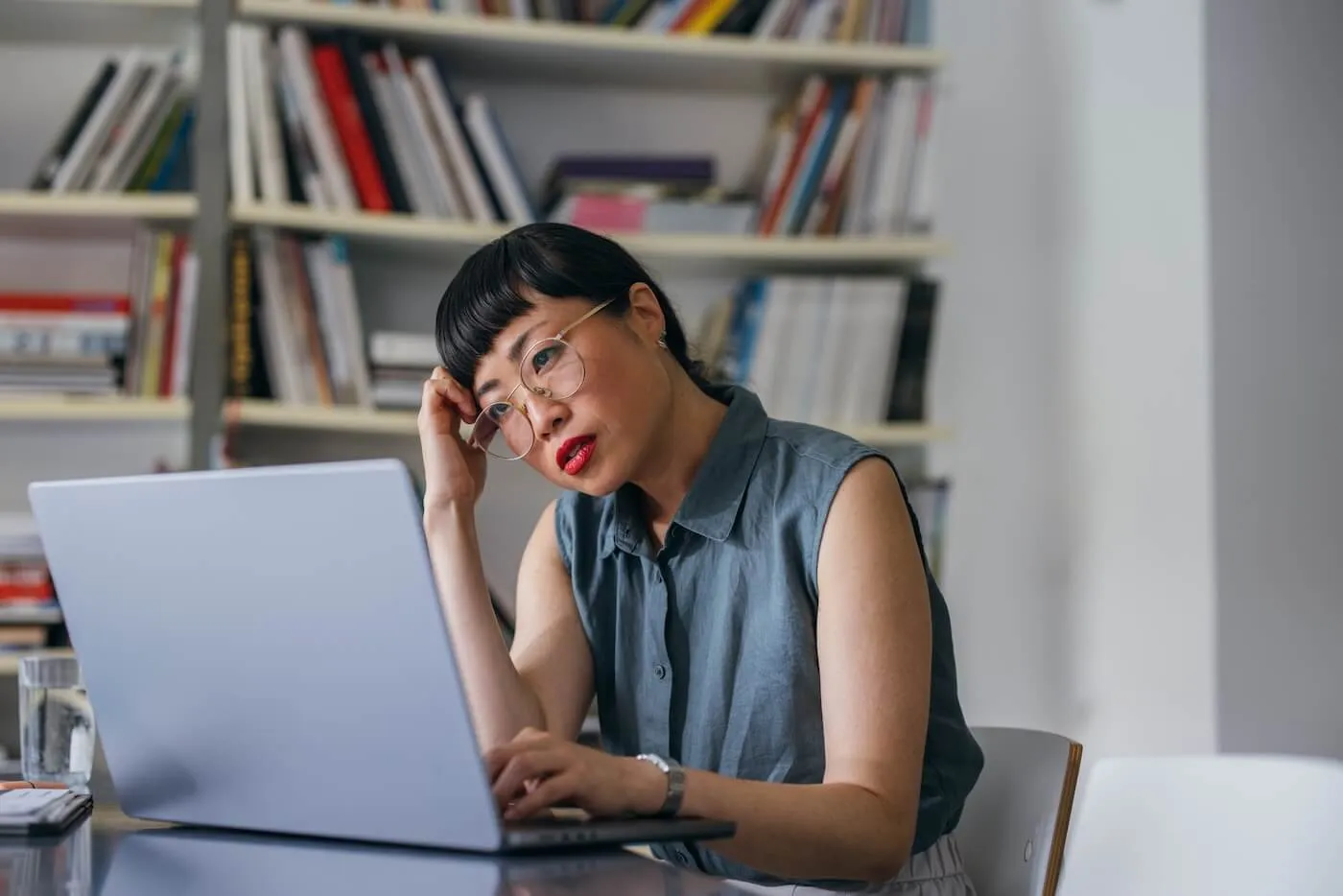 Concern woman using her laptop in a home office