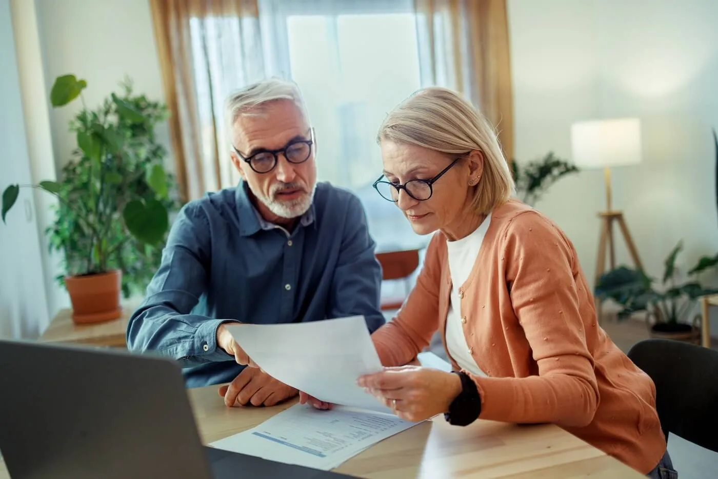 Mature couple planning finances at home