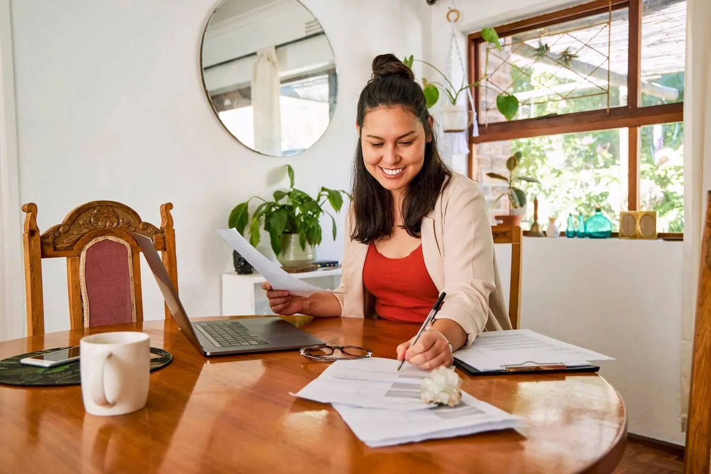 Smiling woman filing taxes at home