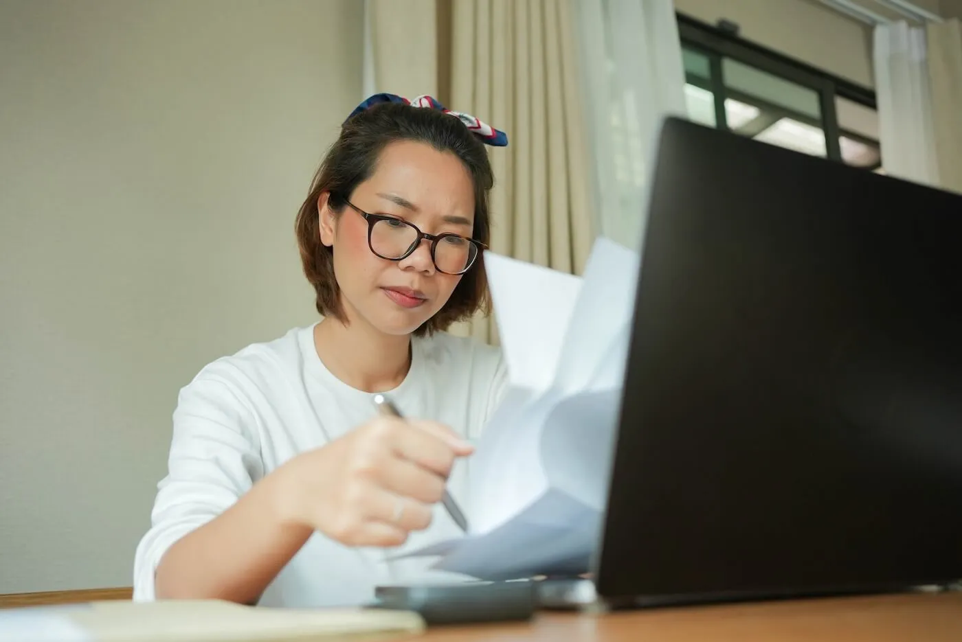 Focused young woman filing taxes online