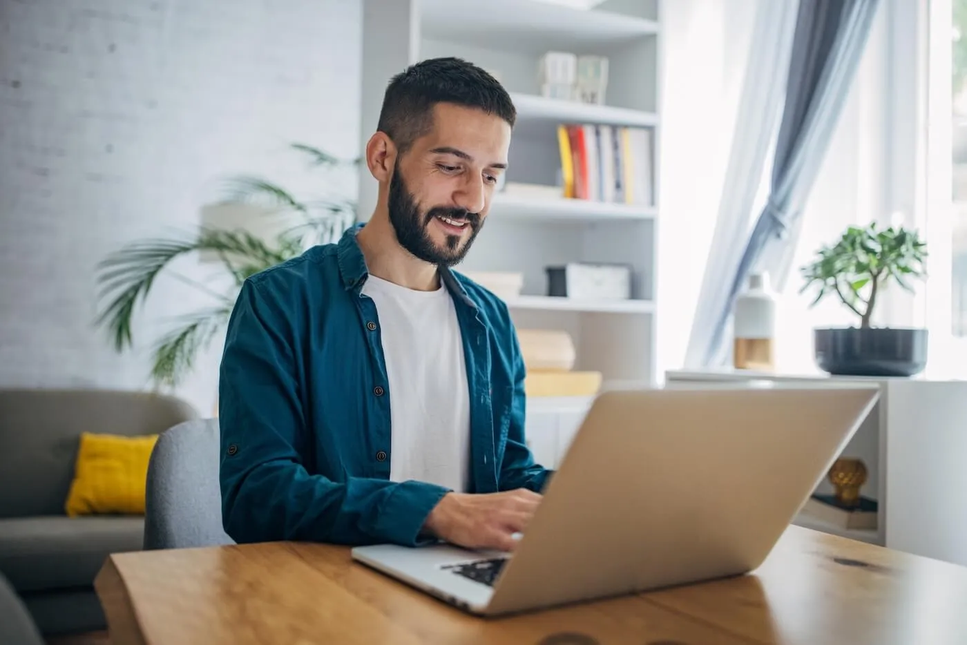Young man using a laptop at home