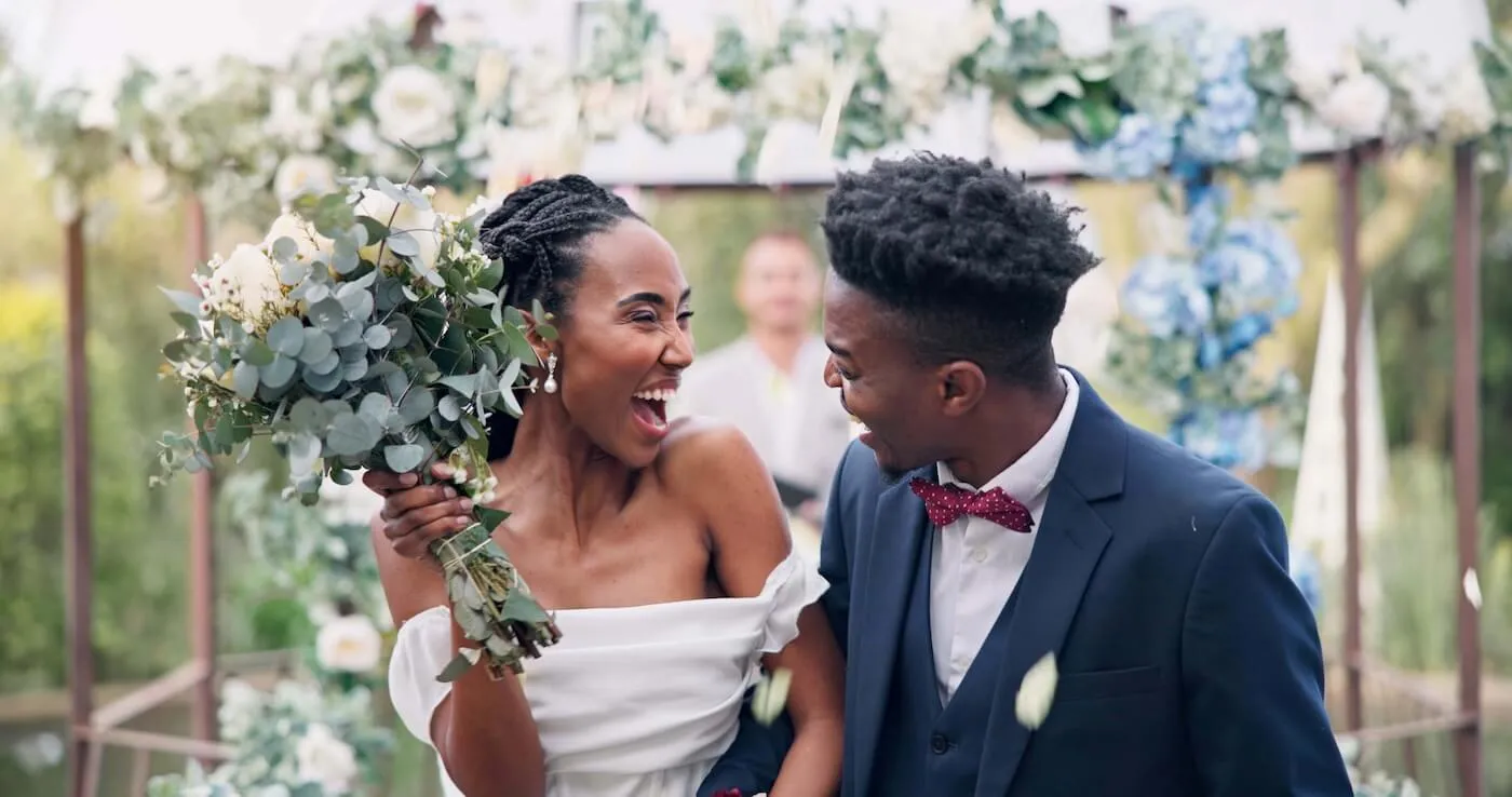 Happy bride and groom standing together after their wedding ceremony, smiling and celebrating their special moment
