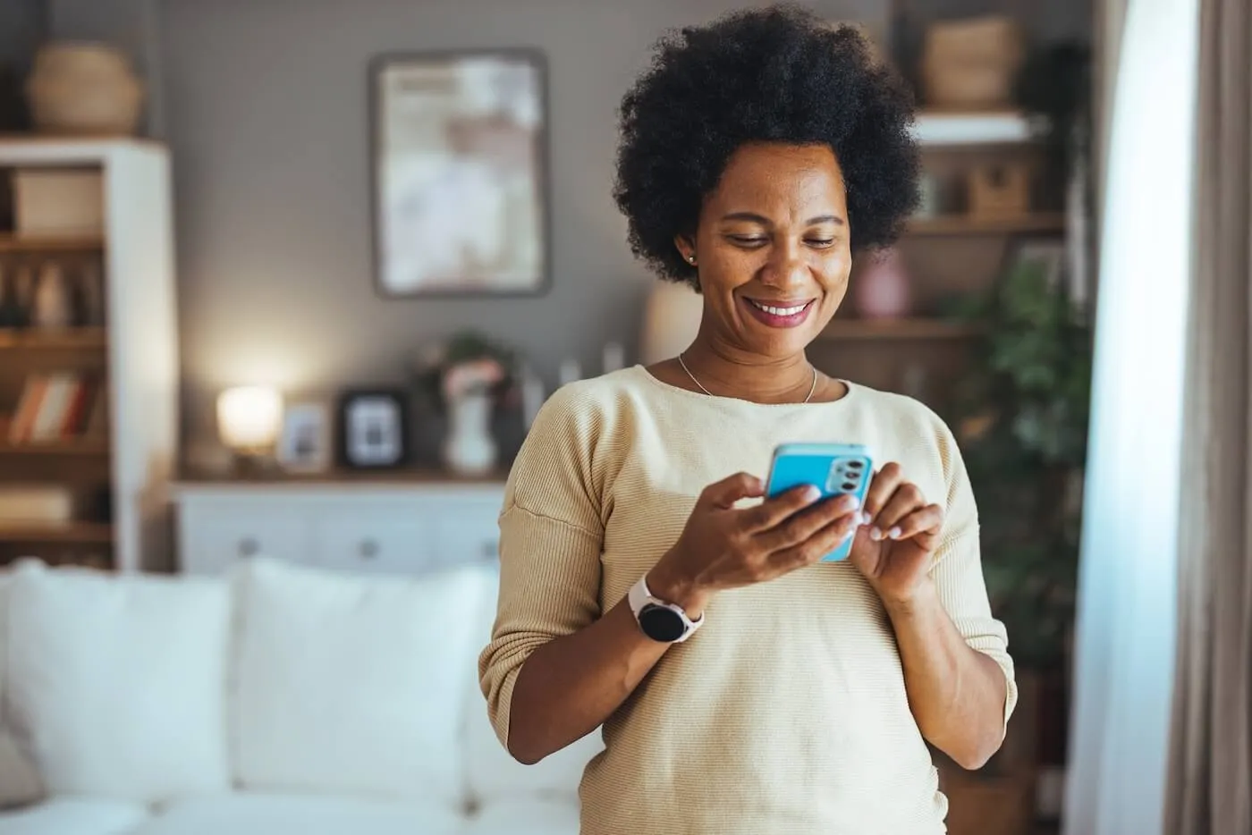 Smiling mature woman checking her credit score in a mobile app
