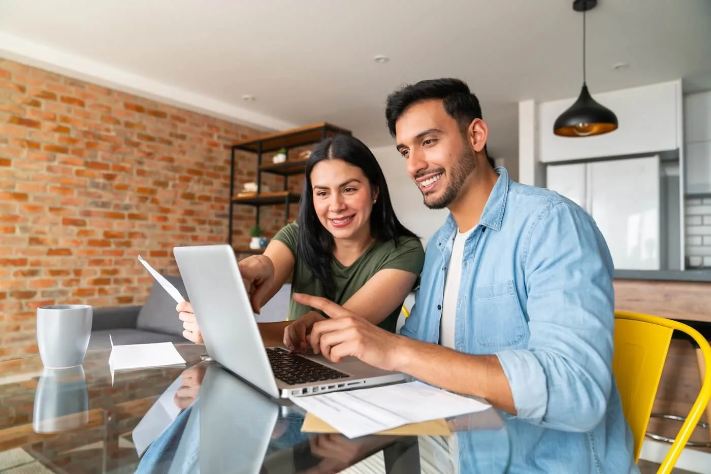Young couple using laptop at home