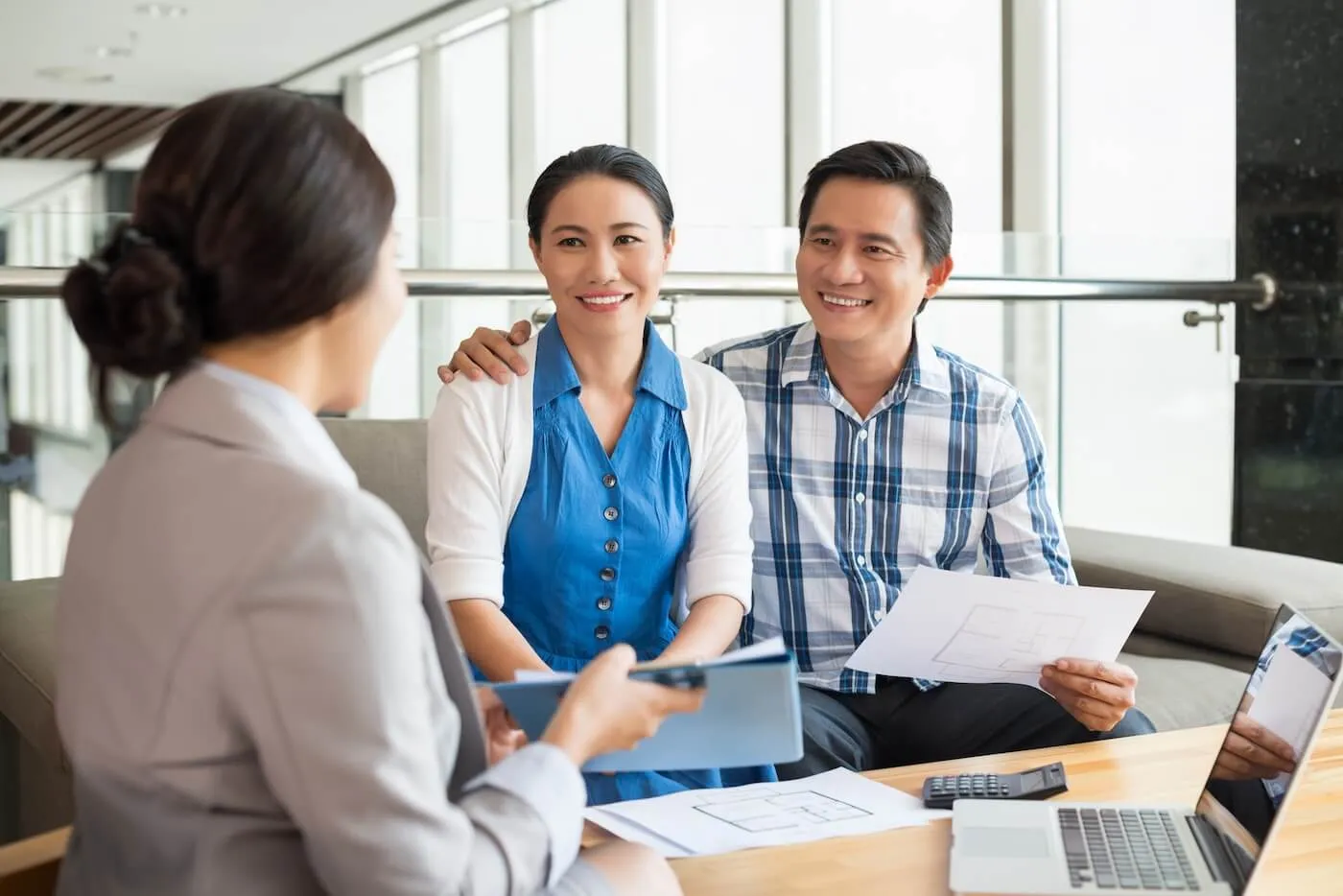 Couple discussing finances with a female consultant