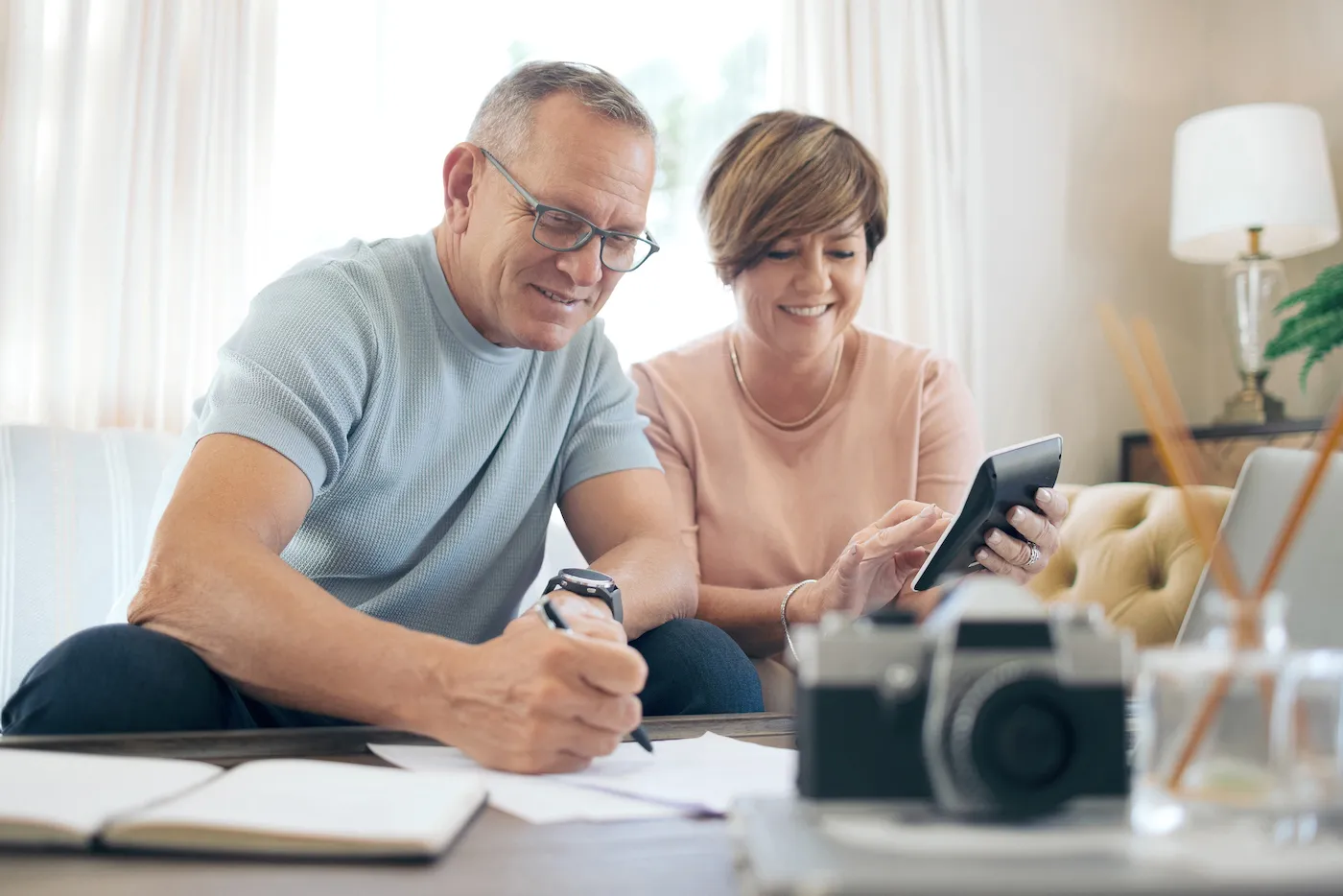 Mature couple calculating savings and researching thhrift savings plan