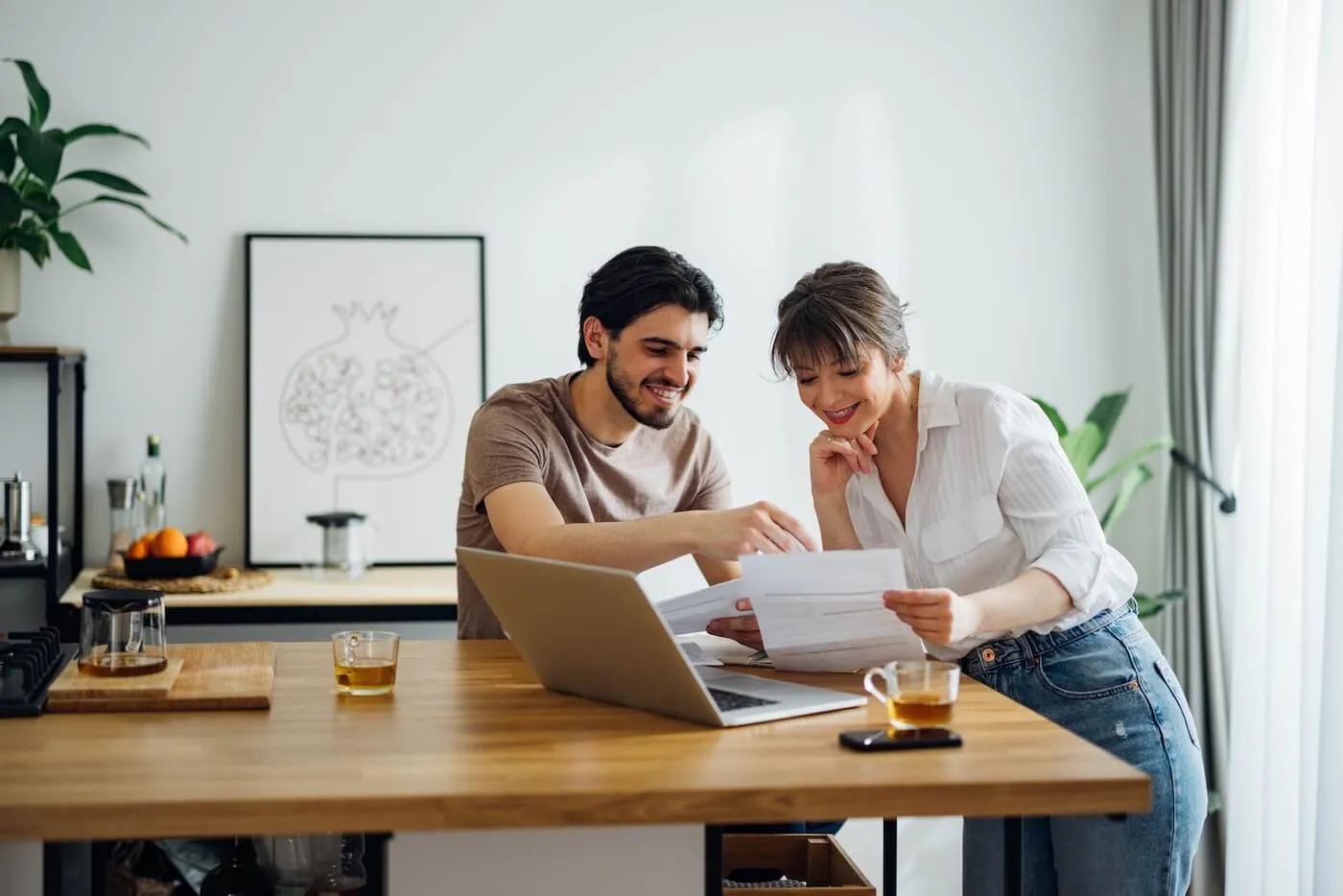 Happy young couple planning finances at home