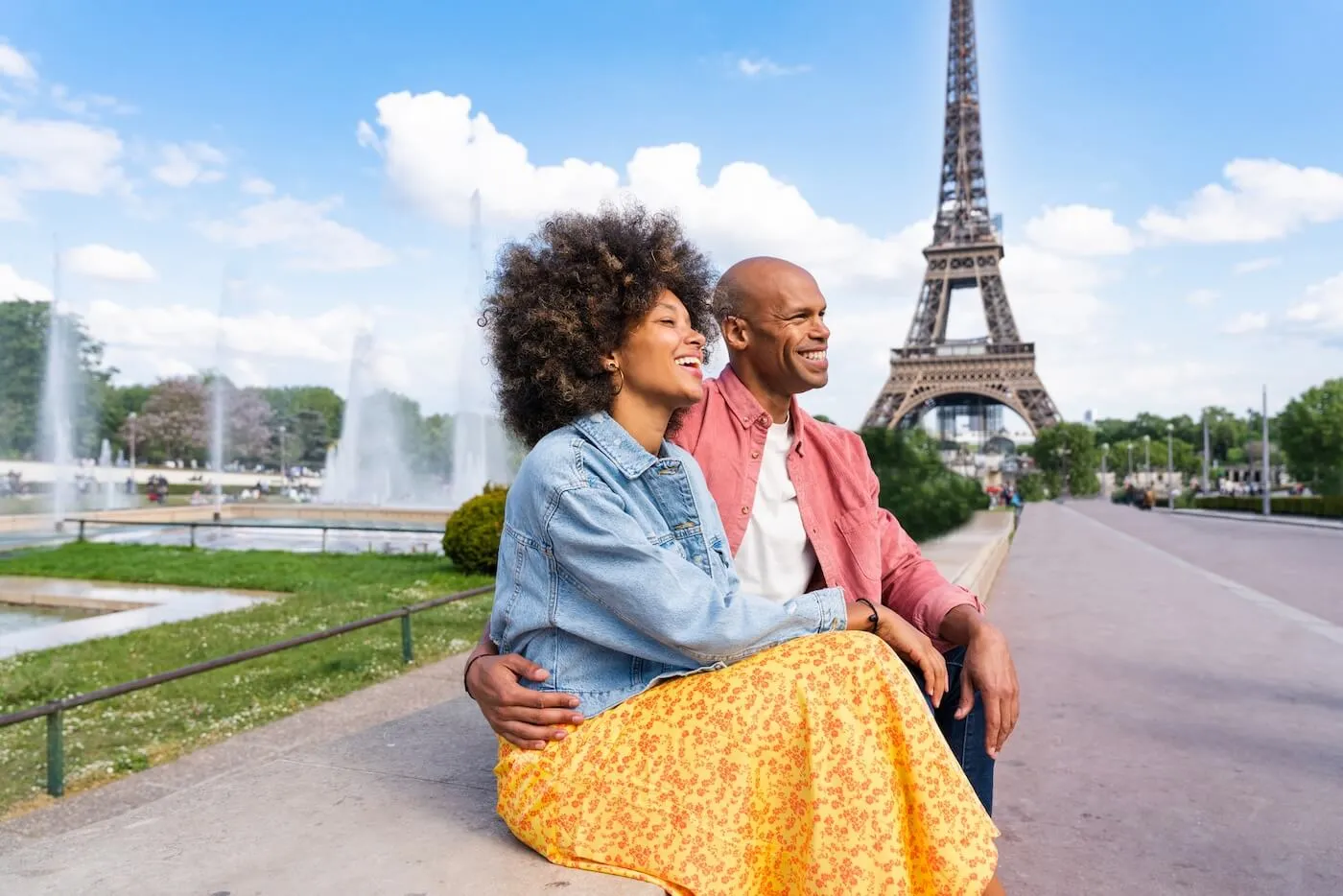 Happy young couple enjoying a sunny day near the Eiffel Tower in Paris