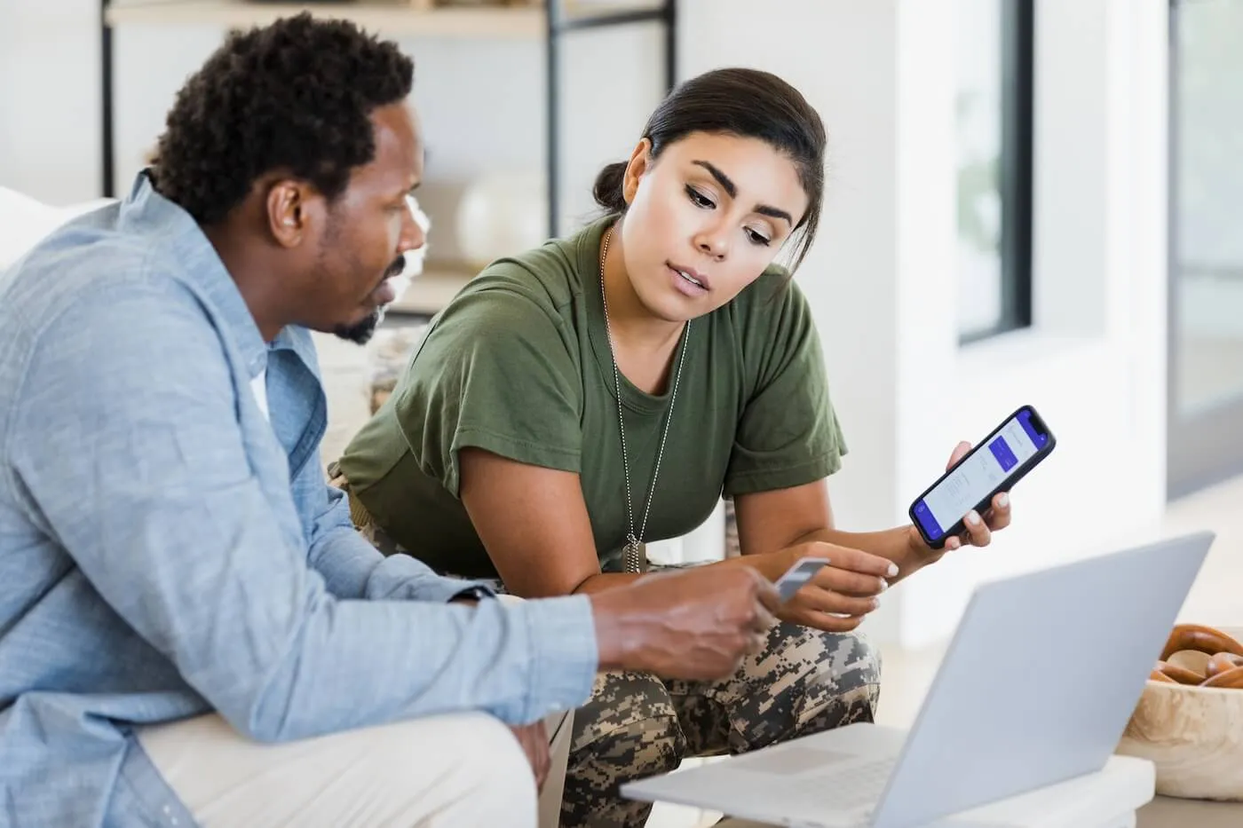 A military woman discussing finances with her partner at home