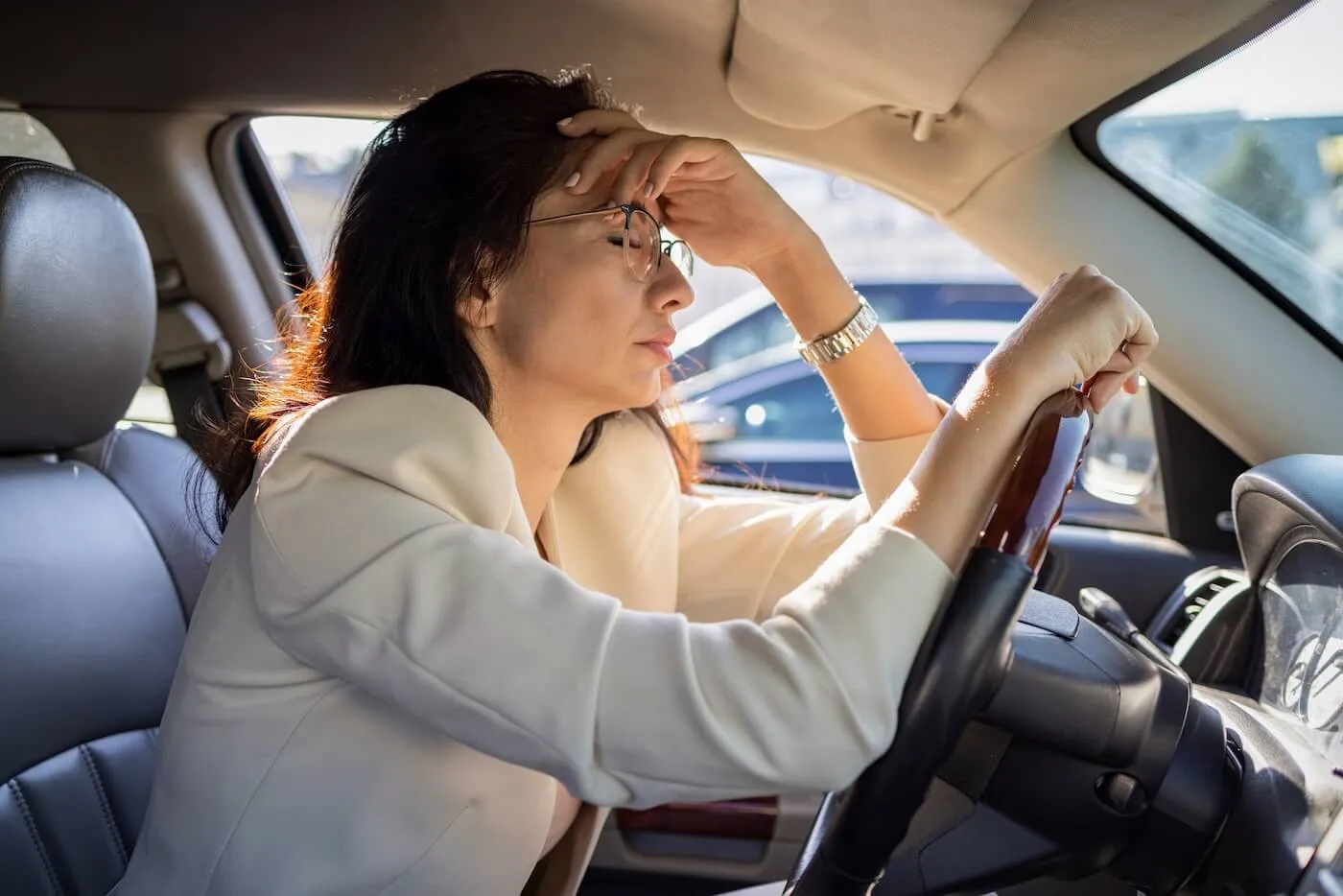 Tired and upset businesswoman sitting behind the wheel