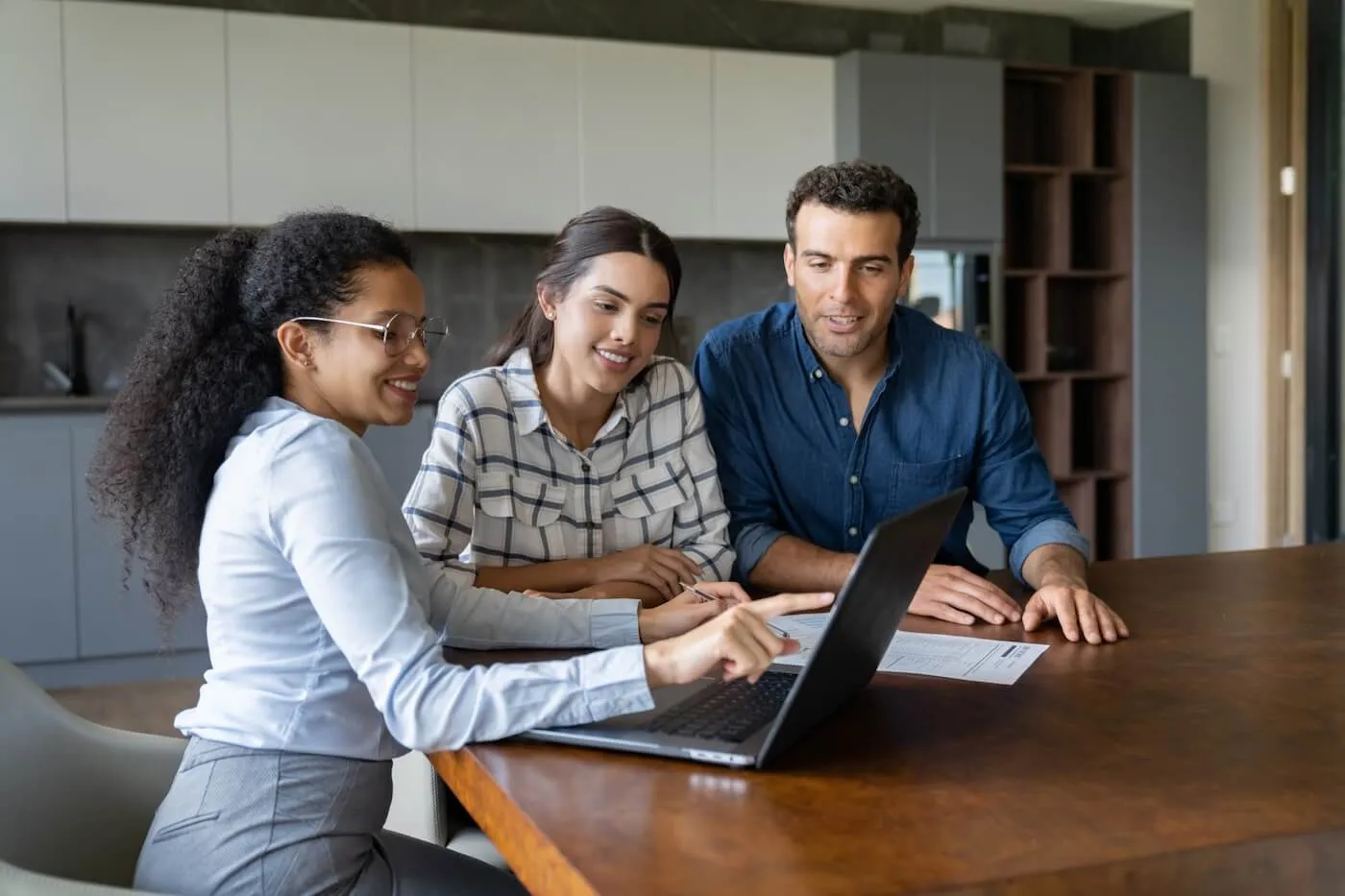 Couple discussing the mortgage options with a female real estate agent