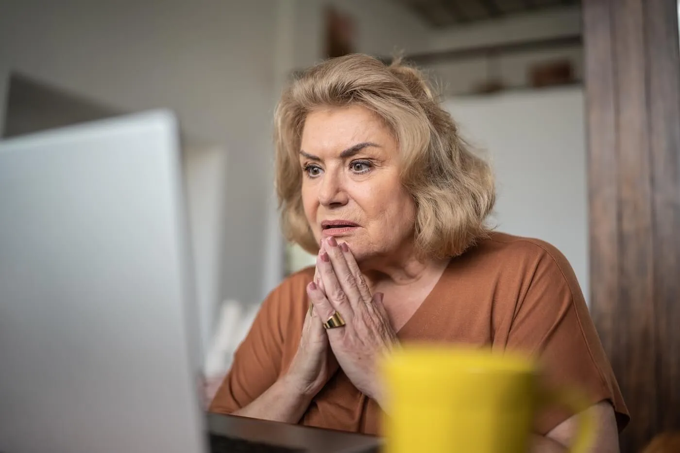 Concerned senior woman looking at the laptop screen