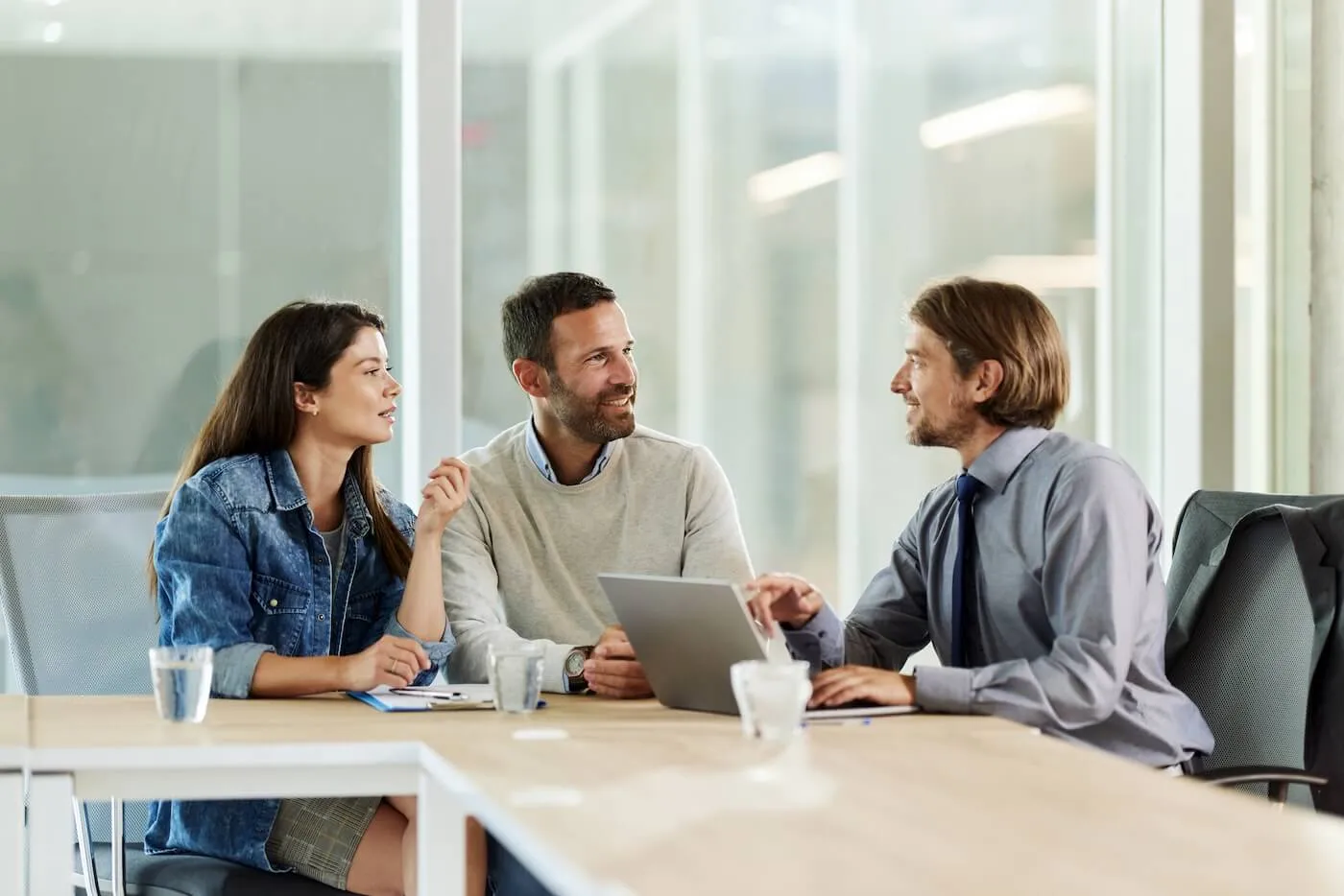 Couple talking to a lender in his office