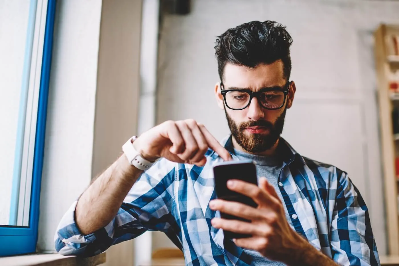 Focused young man using his smartphone