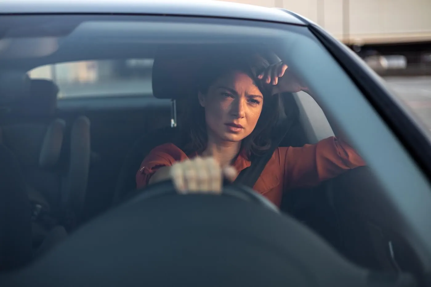 Upset woman driving a car