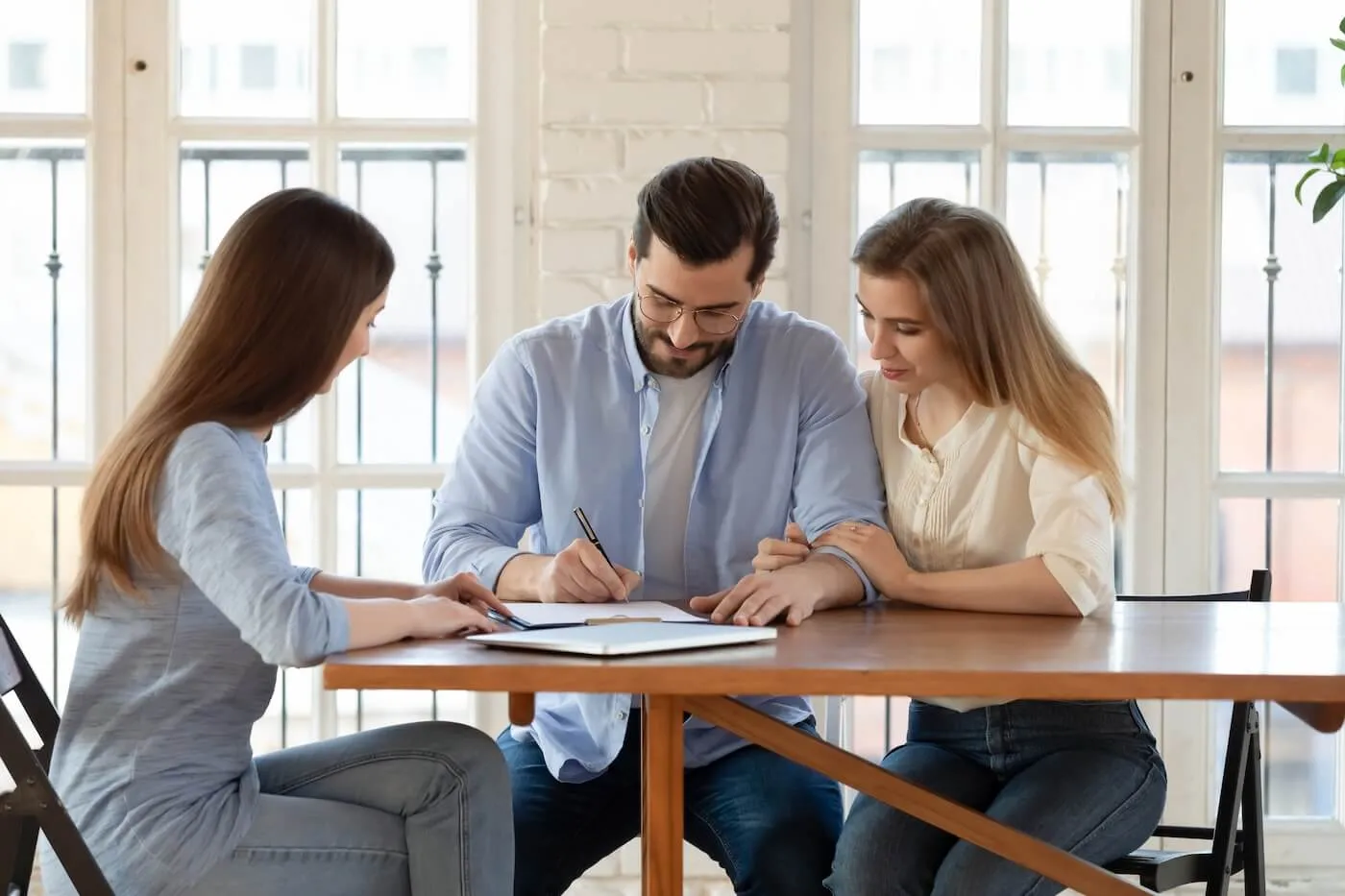 Couple signing papers in the real estate agent's office
