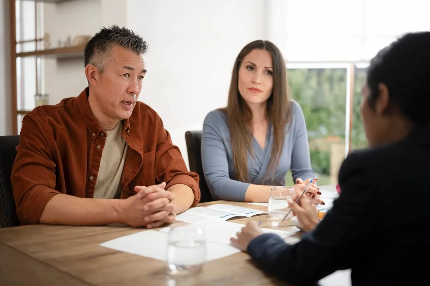 Mature couple having a conversation with a financial adviser at home