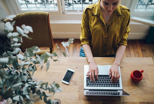 A woman researches how to create a budget with the 50/30/20 rule.