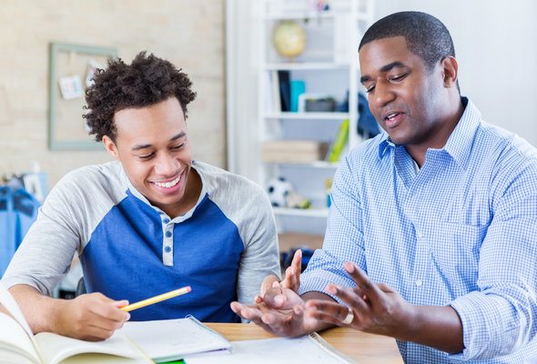 A father and son reviewing their college savings plan.