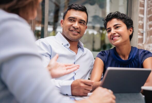 A couple meet with their financial advisor.