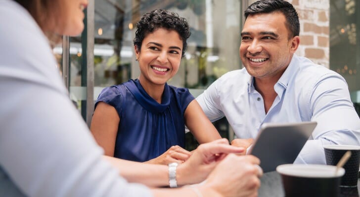 A couple discuss how to create a living trust in Oregon with their financial advisor.