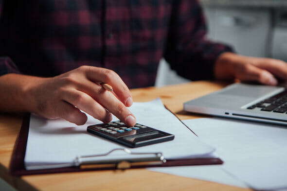A man calculating how much a financial advisor will cost him.