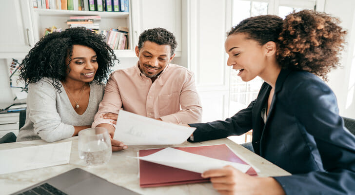 A financial advisor reviewing a financial plan with new clients.