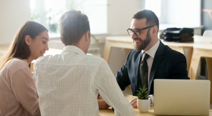 A couple discussing executor fees with their advisor.