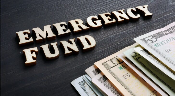 Letters spelling out "emergency fund" above loose cash.