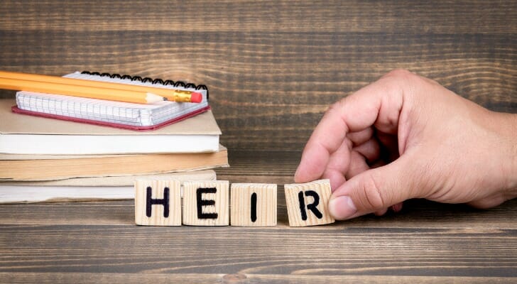 Wooden blocks spelling out "heir."