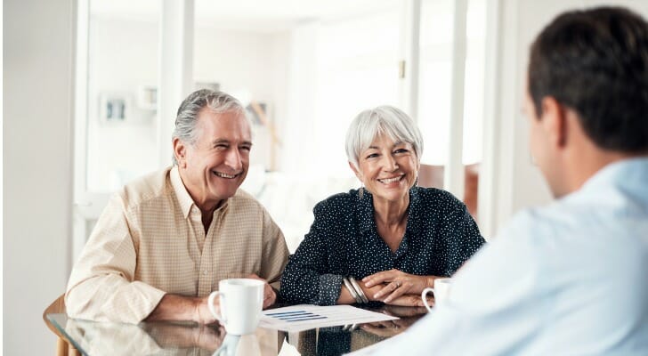 A couple discussing the 401(k) Rule of 55 with their advisor.