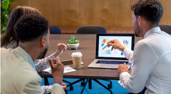 A financial advisor goes over a married couple's investment portfolio with them.