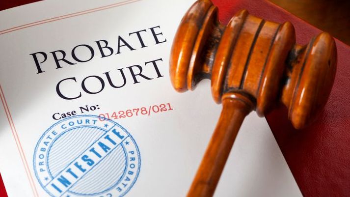 A judge's gavel rests on top of documentation for a probate case.
