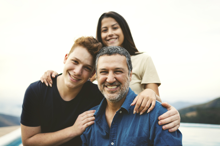 A father with his children, considering if he can retire at 61.
