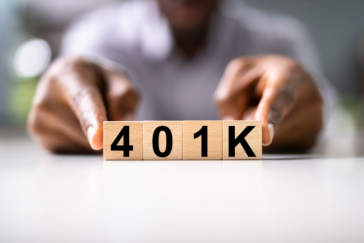 Black man holding 401(k) blocks together with the tips of his index fingers.