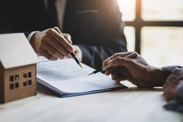 An estate planner and client discuss who pays the mortgage on a house in a trust.