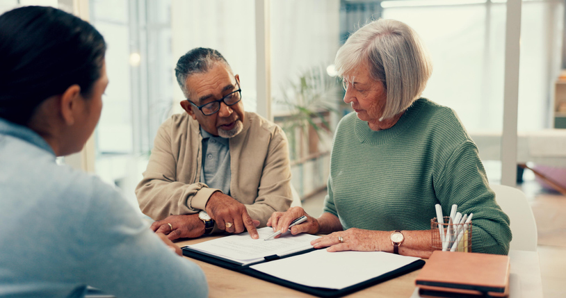 A couple discuss life insurance with their advisor.